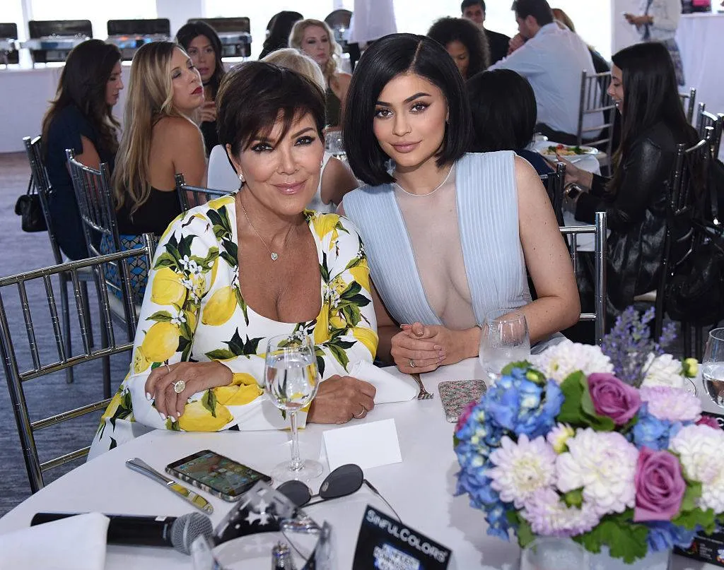 kris and kylie jenner sitting at a table