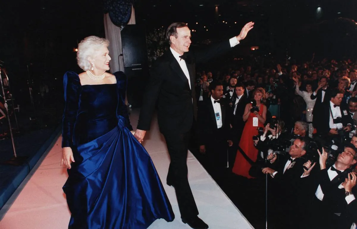 George H.W. and Barbara Bush wave at the crowd of the 1989 inauguration.