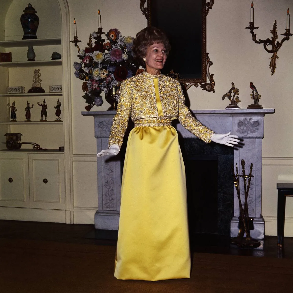 In her apartment, Pat Nixon models the gown that she wore to the Inaugural Ball.