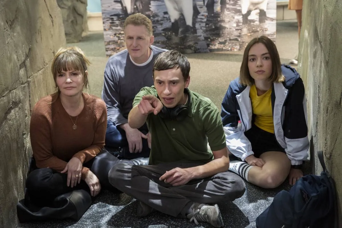 cast of atypical sitting in an aquarium