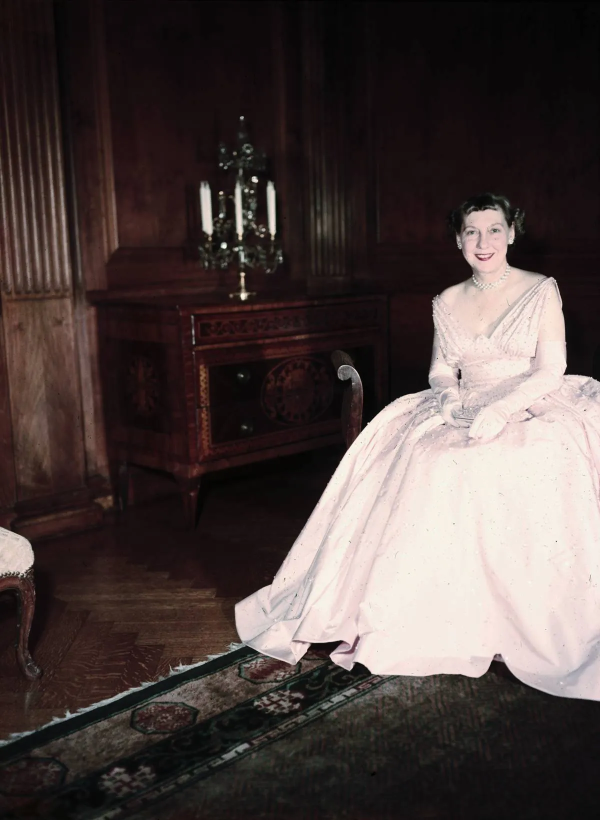 Mamie Eisenhowever sits in her white inaugural ball gown.