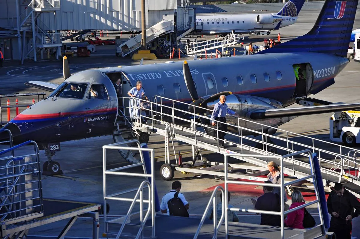 Passengers deboard an Embraer EMB-120ER Brasilia.