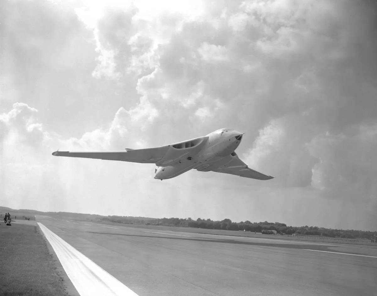 A Handley Page Victor bomber lands on an airstrip.