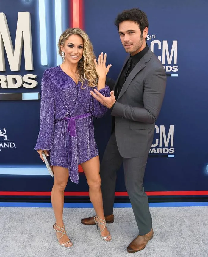 Kasi Williams shows off her wedding ring with her husband, Chuck Wicks, on the ACM 2019 red carpet.