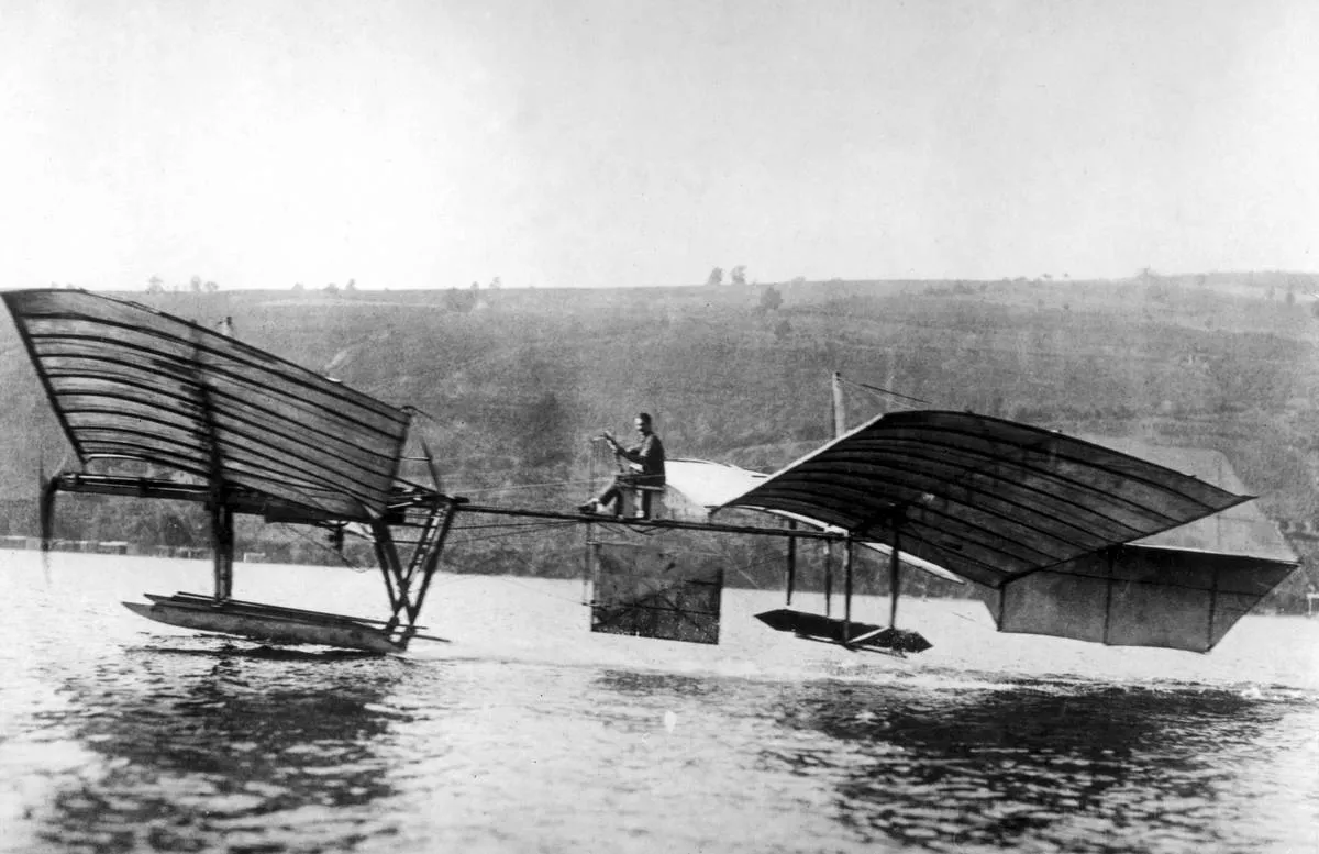 Glenn Curtiss flyies the modified Langley 'aerodrome' above the water.