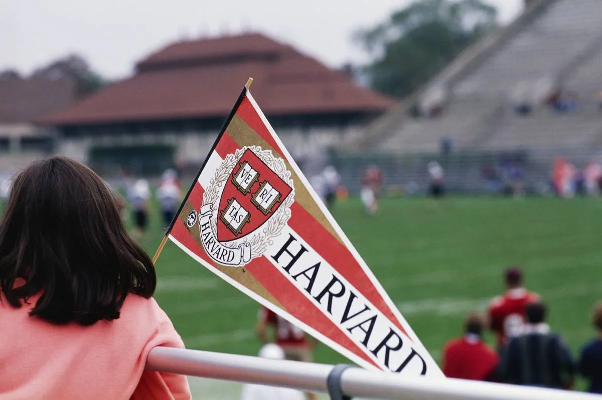 Girl with Harvard Pennant Watching Football Practice