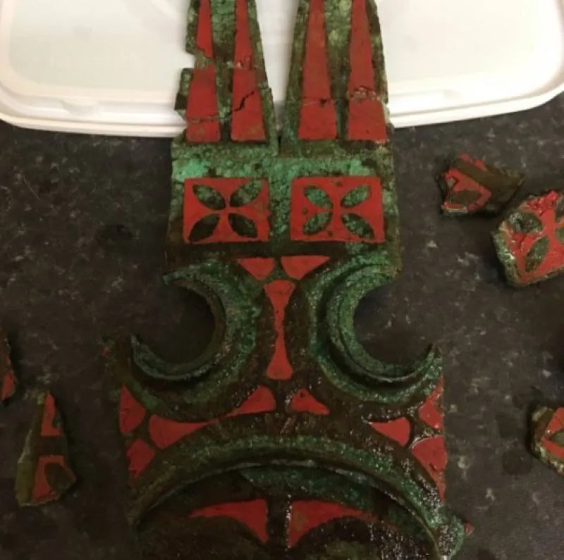 a red and green artifact from the iron age
