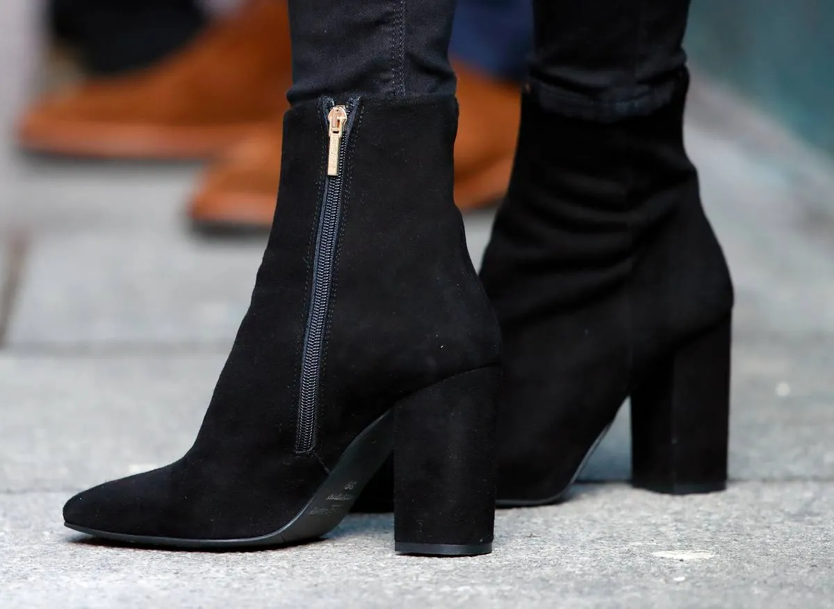 A close-up shows black boots that Kate Middleton wore while visiting the National Centre for Youth Mental Health in Ireland, 2020.