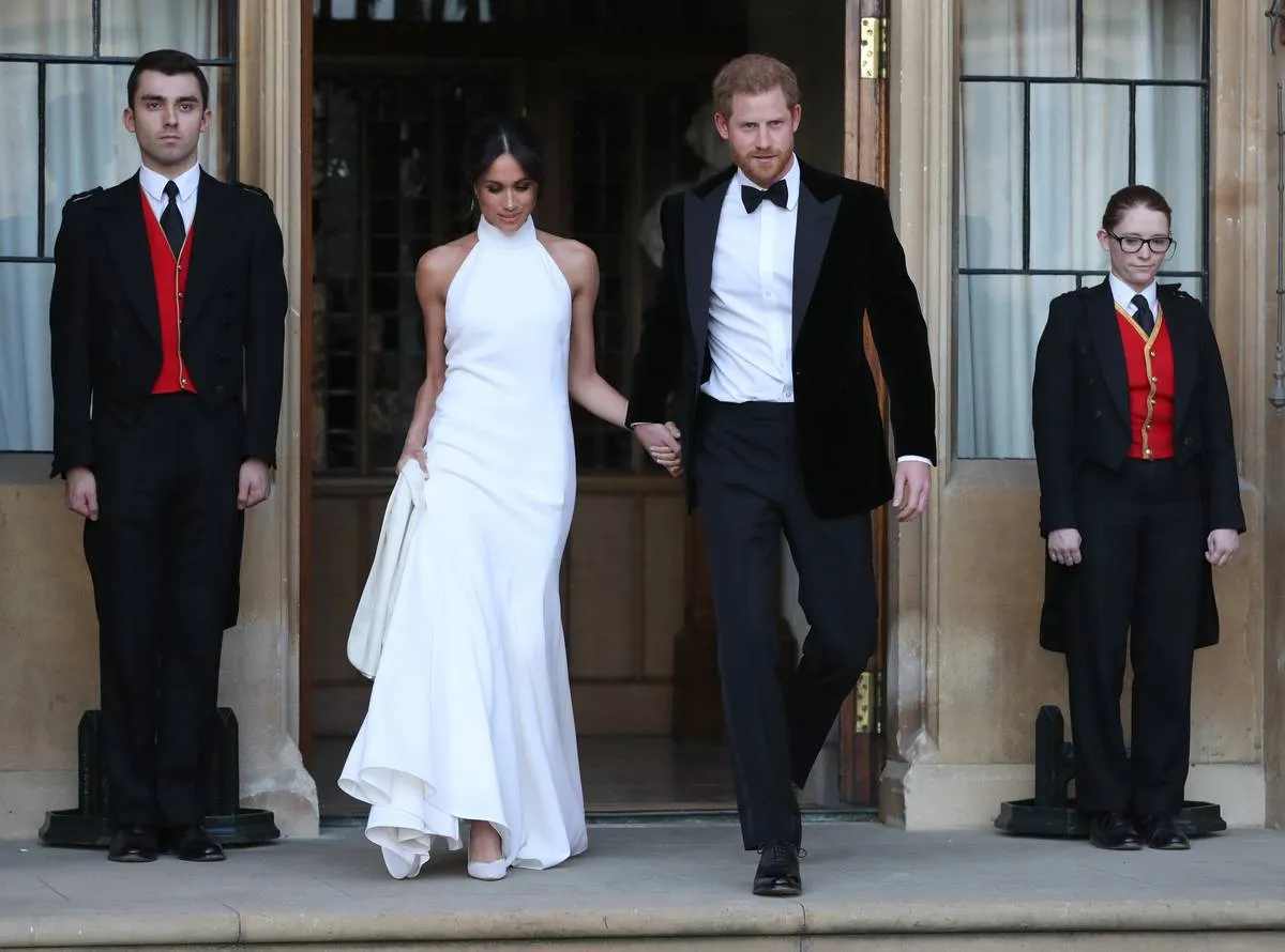 Meghan Markle and Prince Harry leave their wedding to attend the celebrations.