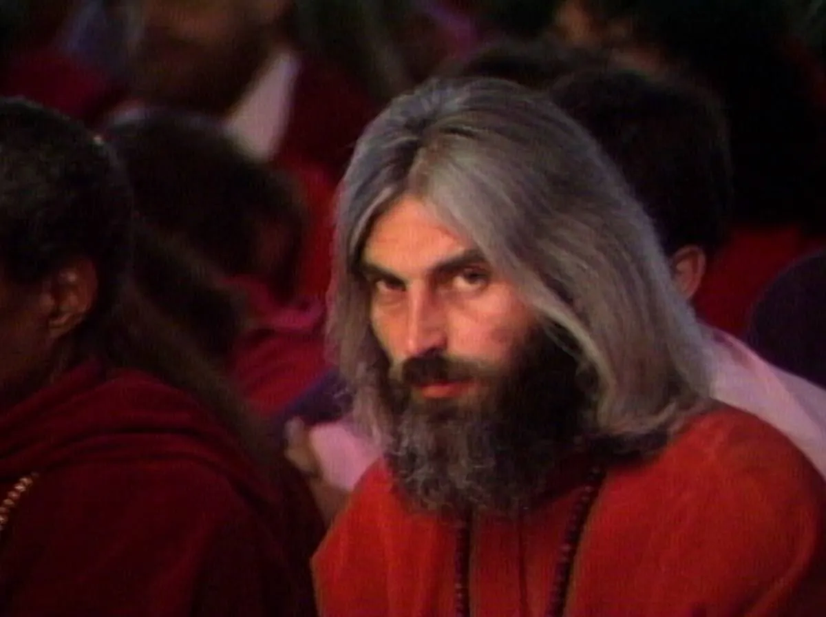 man with long hair and beard in wild wild country