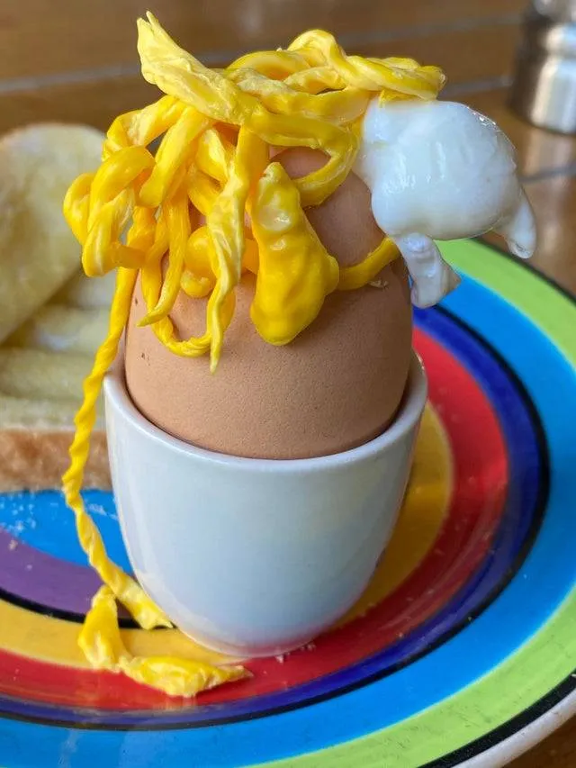 boiled egg that has stringy eggs exploding out of it 