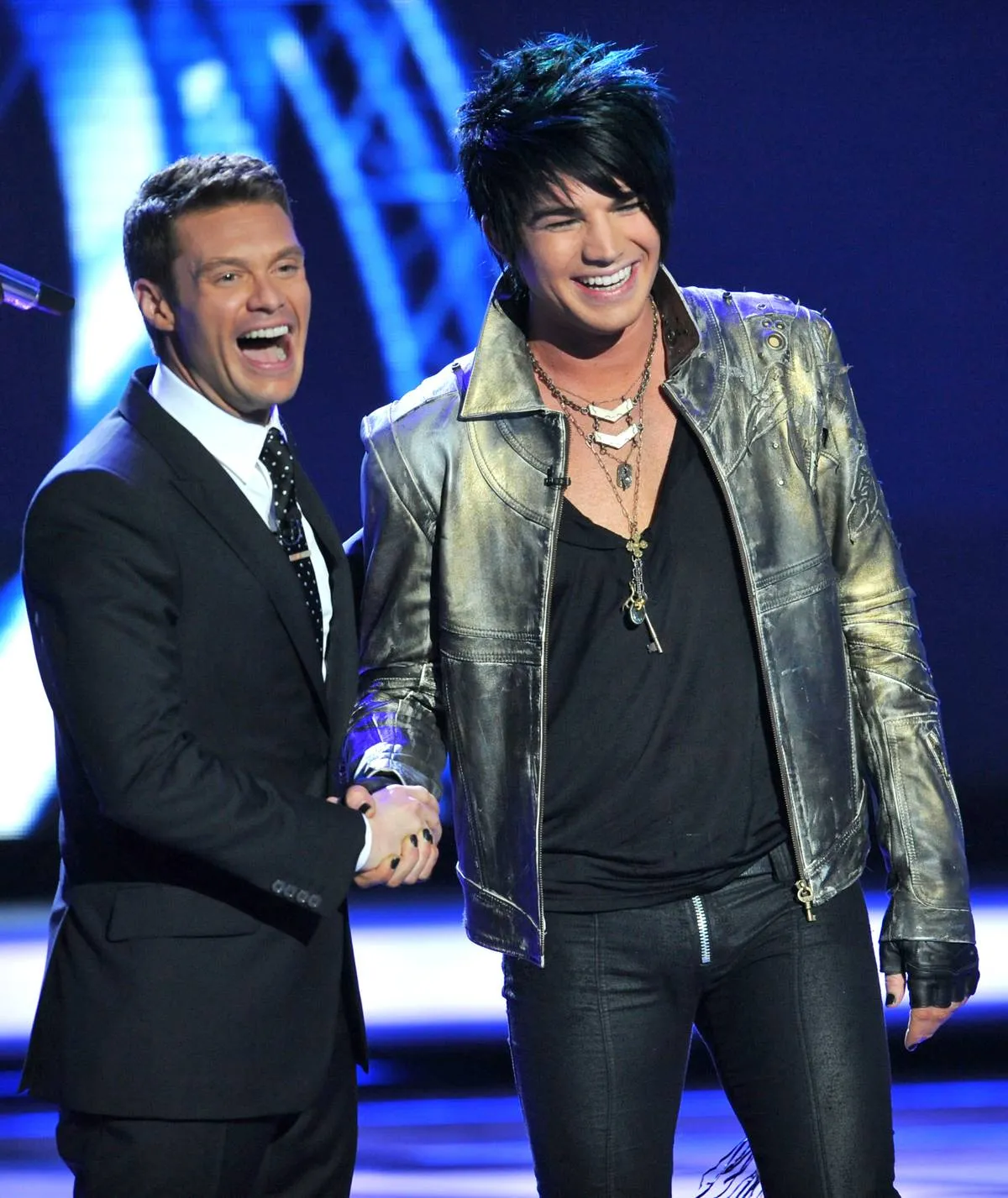 Adam Lambert and Ryan Seacrest shake hands on stage during American Idol Season 8.