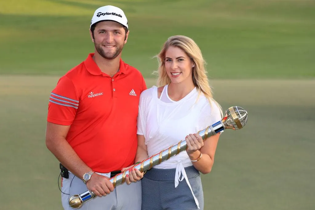 Jon Rahm of Spain poses with the trophy and girlfriend Kelley Cahill