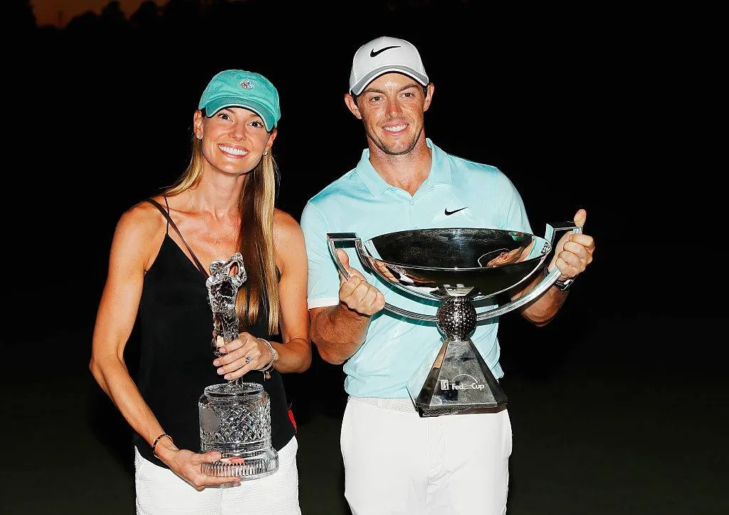 Rory McIlroy And Erica Stoll holding up a trophy 