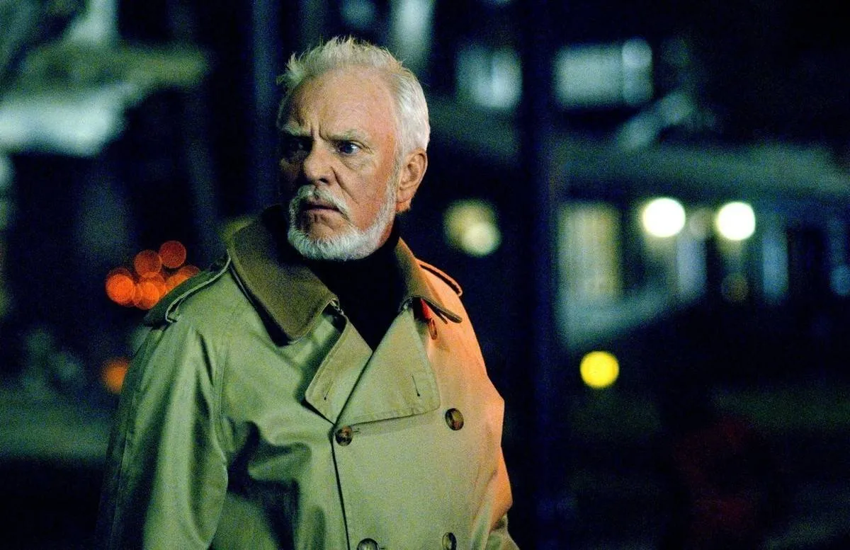 Malcolm McDowell wearing a trench coat in halloween