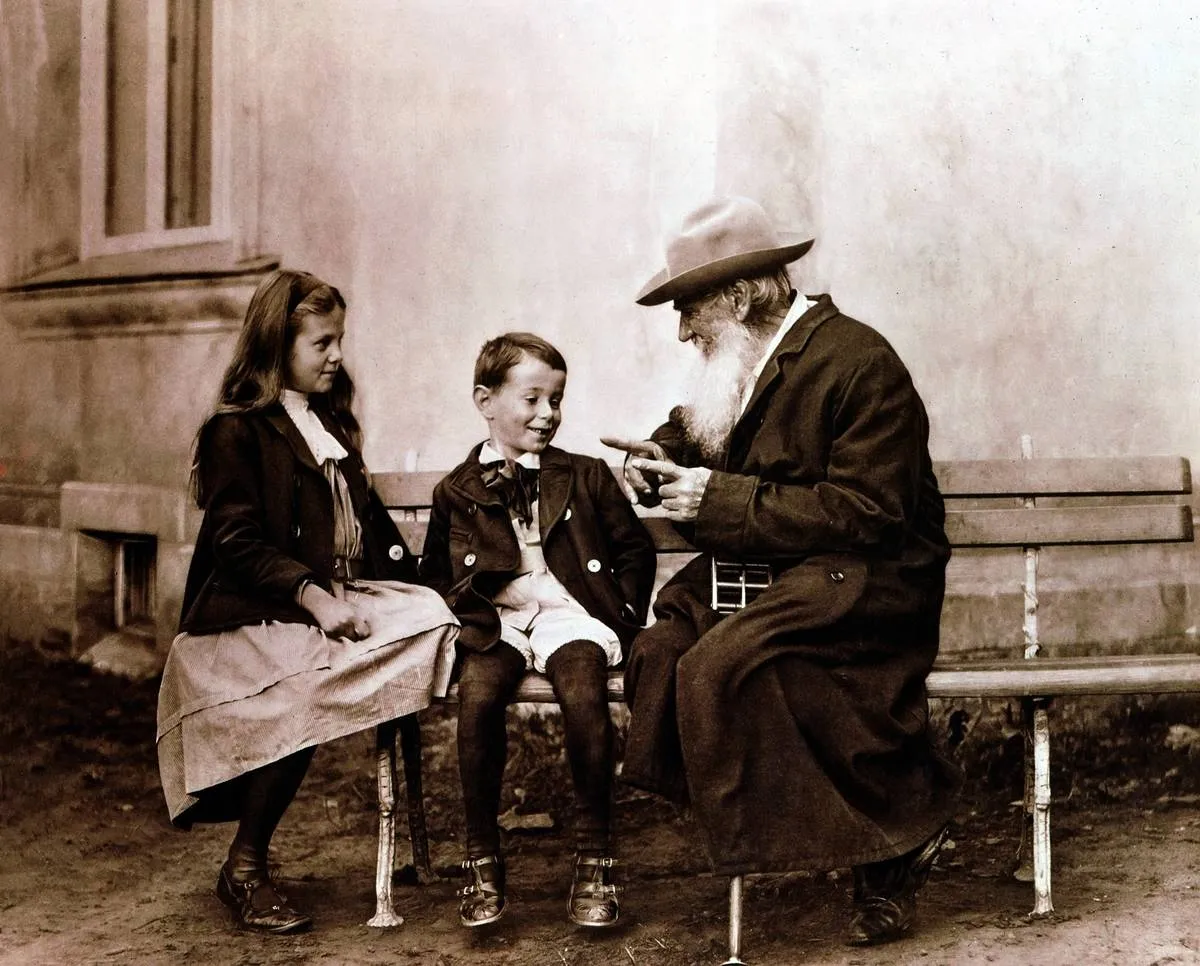 Leo Tolstoy (1828-1910) Russian writer, philosopher and mystic, telling his grandchildren a story. Photograph. ...