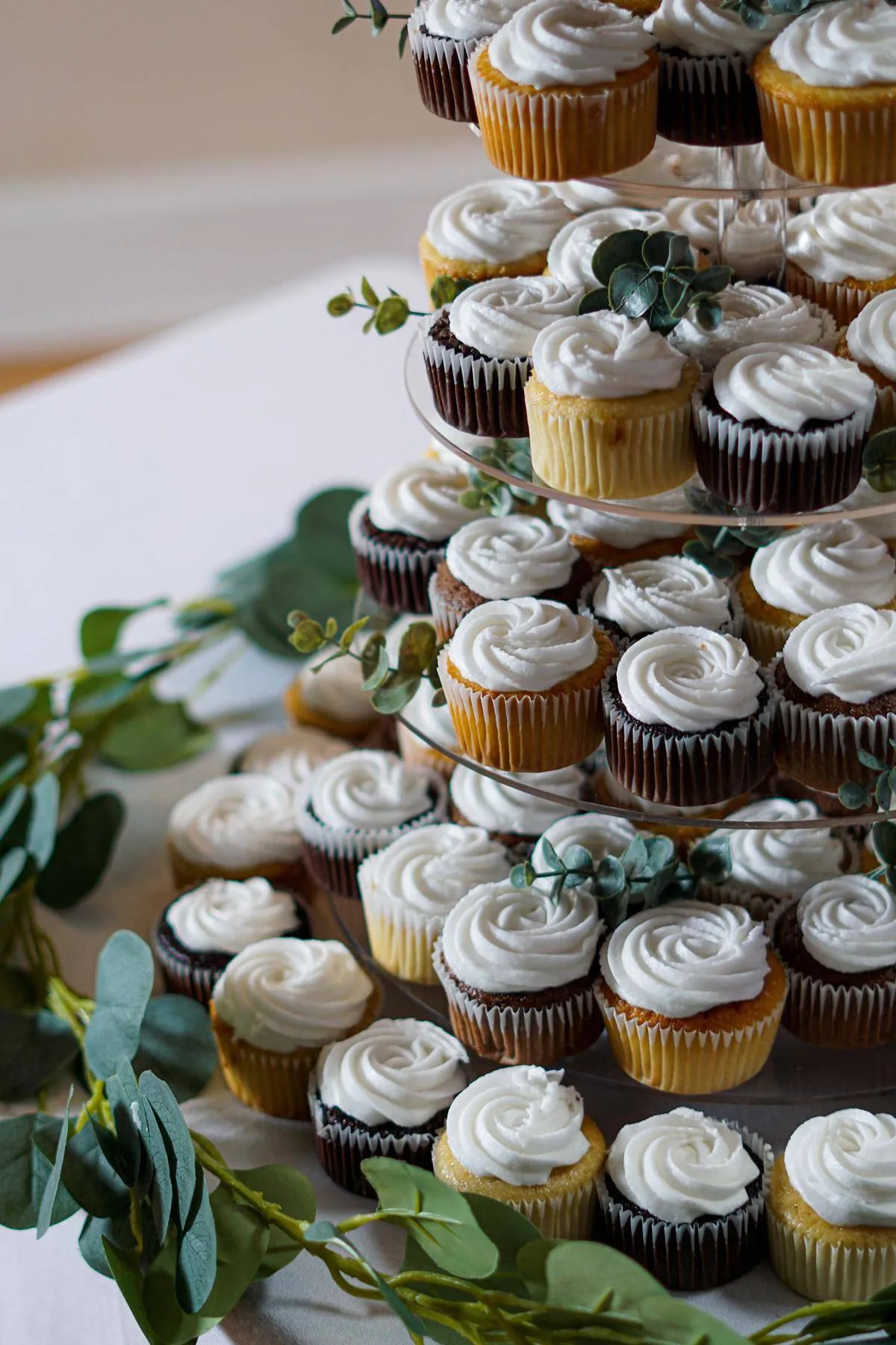 Tower of cupcakes at a wedding dessert table