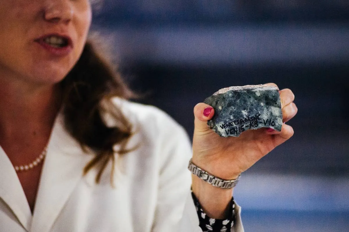 A laboratory scientist holds kimberlite, which contains diamonds.