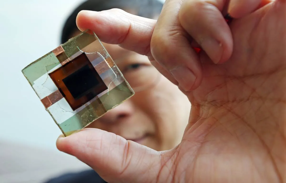 Prof. Charles Chee Surya, poses for a photograph with perovskite-silicon tandem solar cells.