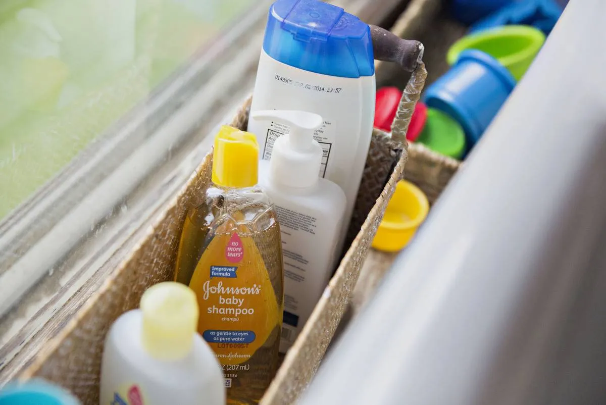 A variety of Johnson's hair care products are arranged in a basket.