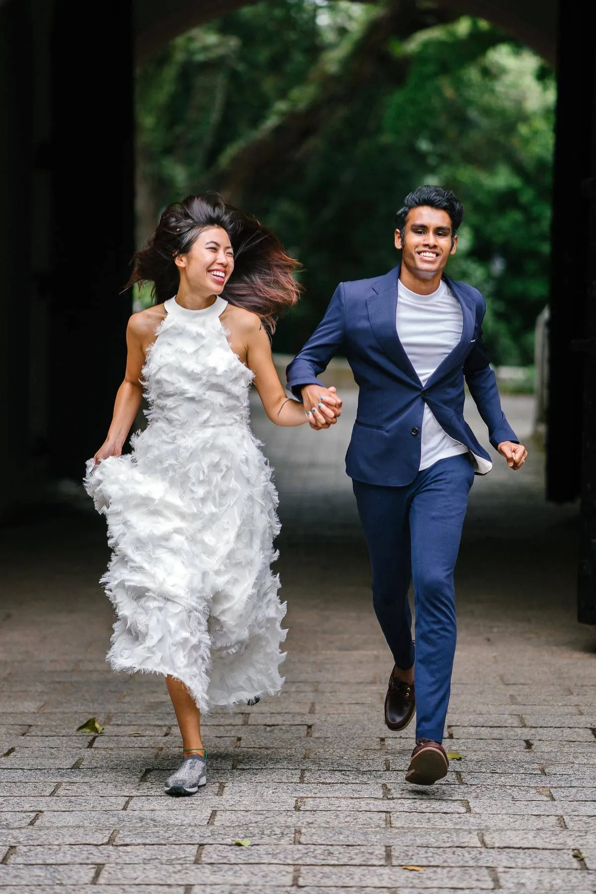 Bride and groom running and laughing together