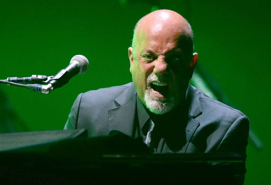 Billy Joel performing at the piano in 2014
