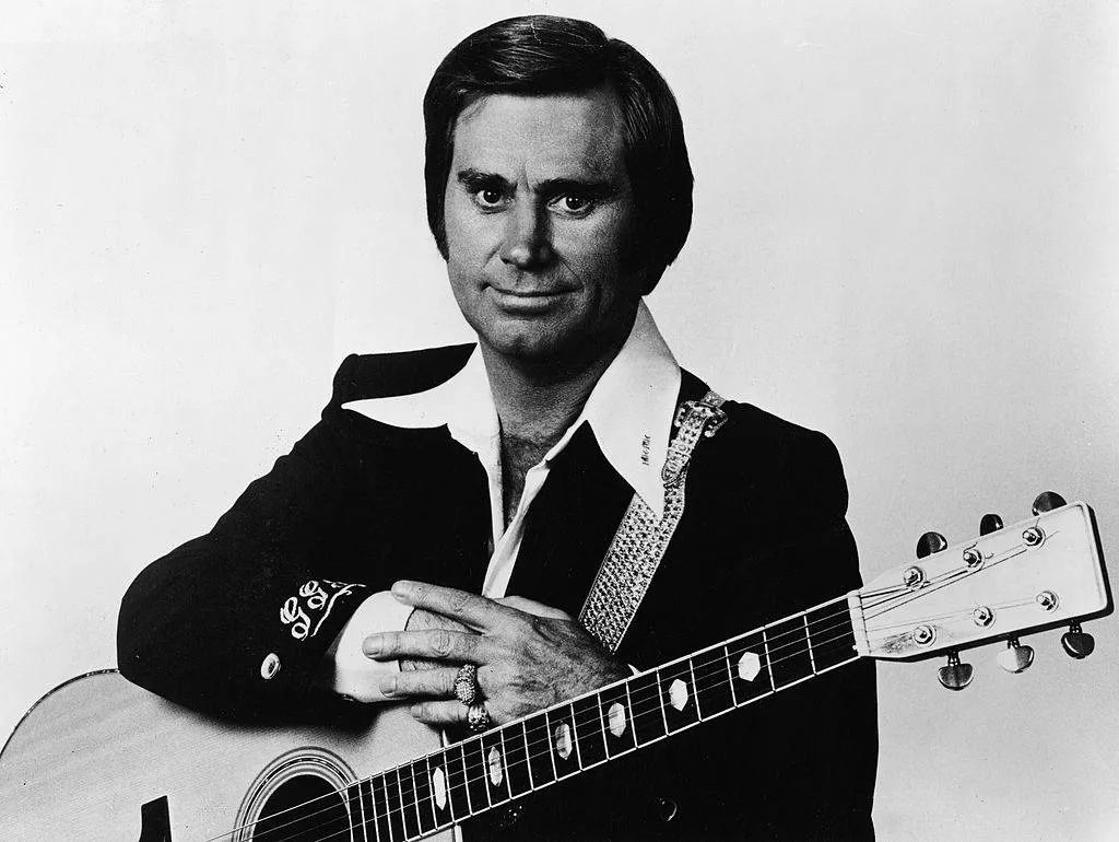 george jones holding a guitar black and white portrait