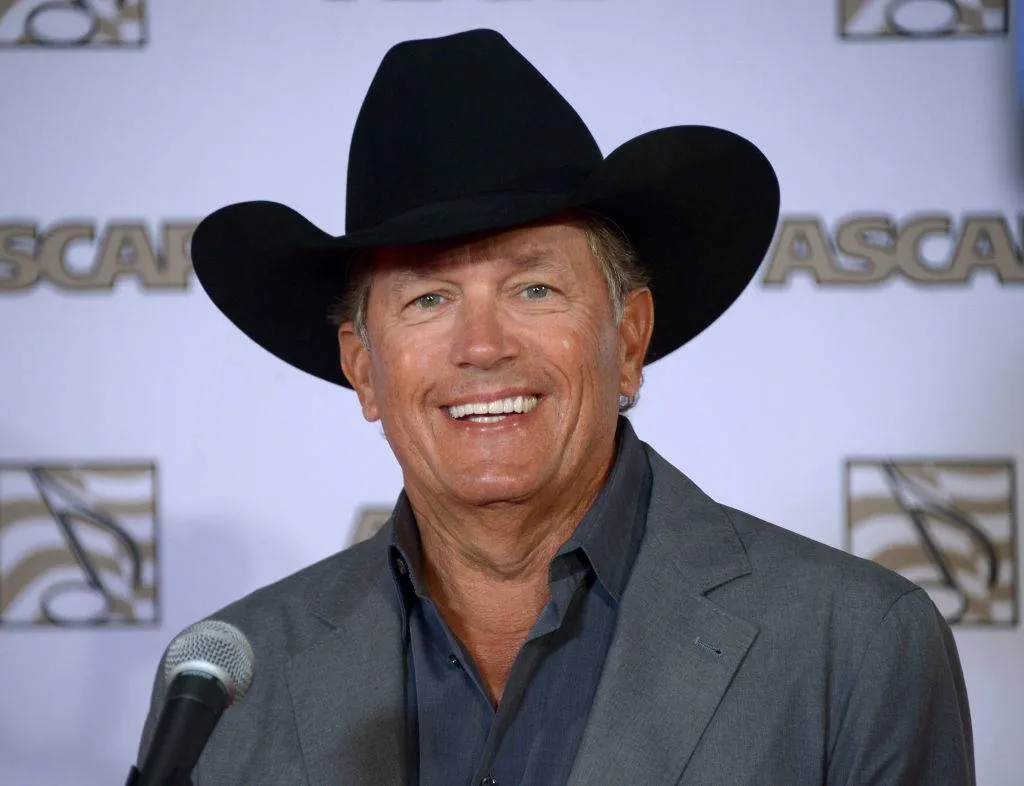 george strait posing for a photo in november 2013