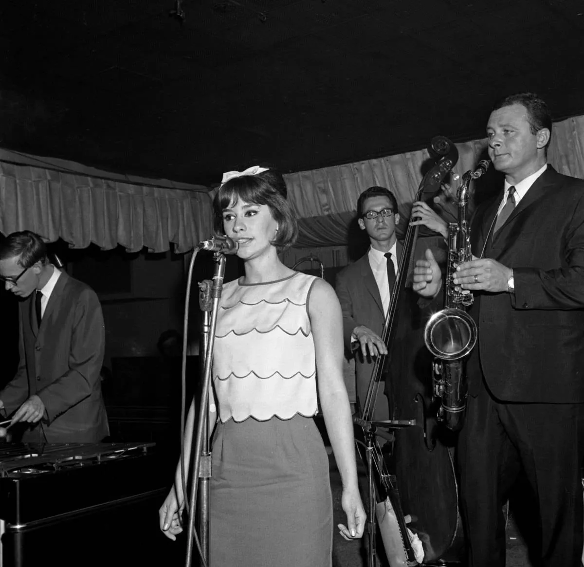 Jazz singer Astrud Gilberto, bassist Gene Cherico and saxophonist Stan Getz perform onstage at Birdland on the day they recorded the live album Getz Au Go Go on August 19, 1964 in New York, New York