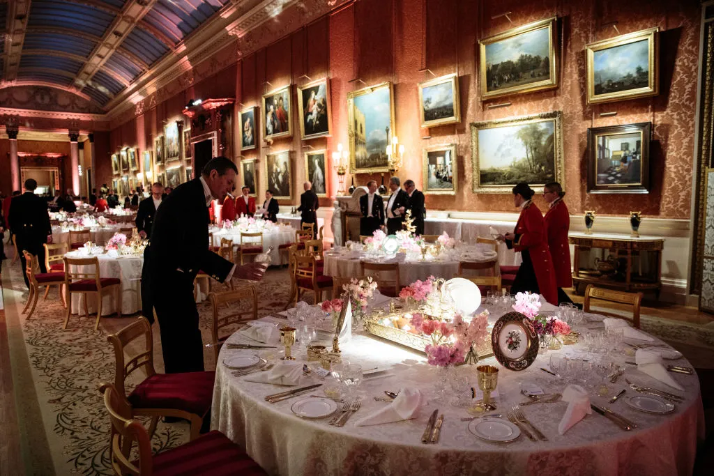 Formal dining table in royal cathedral style hall with places set