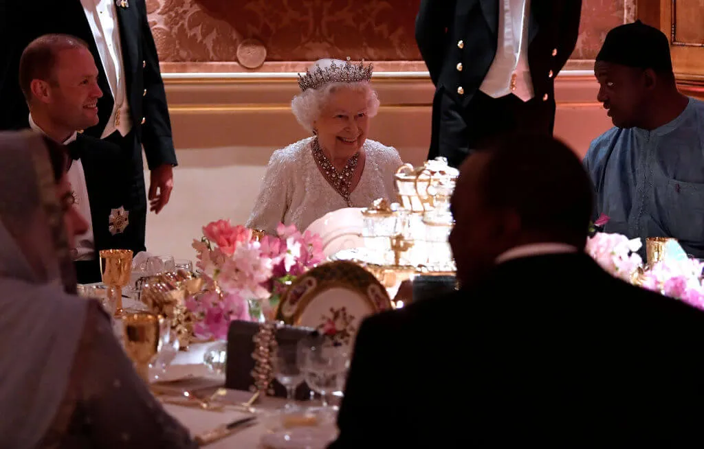 The Queen dines with company at a round table event
