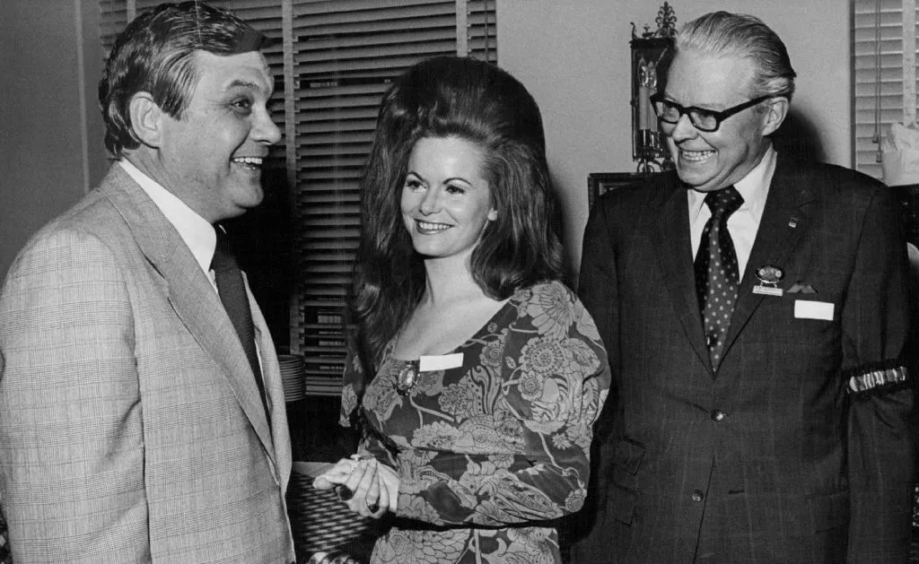 Jeannie C. Riley country music artist poses with two unidentified men