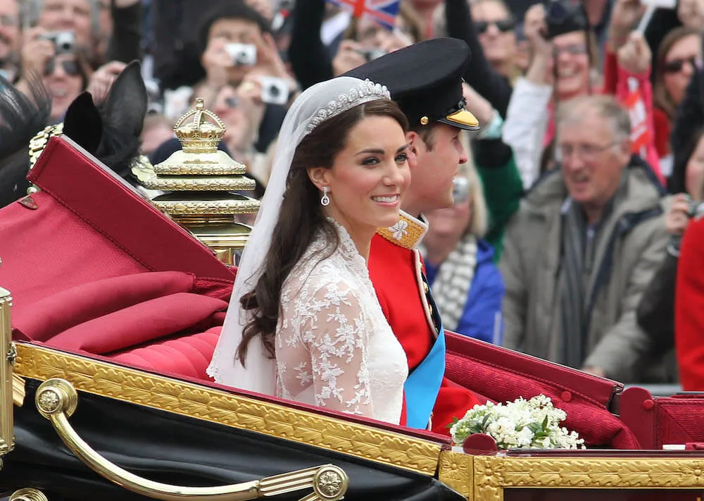 Kate Middleton and Prince William on their wedding day ride in open carraige
