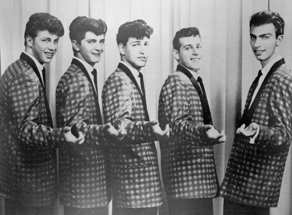 The Elegants band, 5 teenage boys posed in matching checked coats