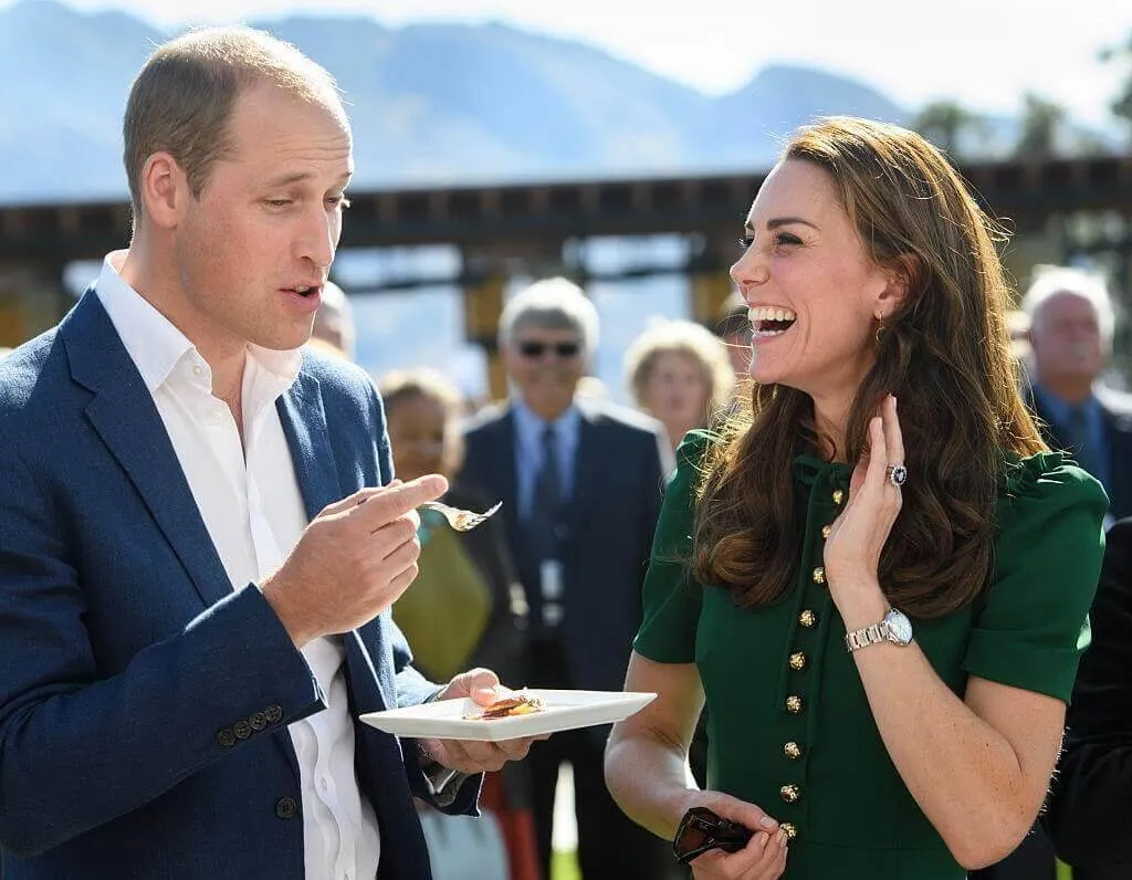 Prince William and Kate Middleton laugh at public event while Will holds fork and plate