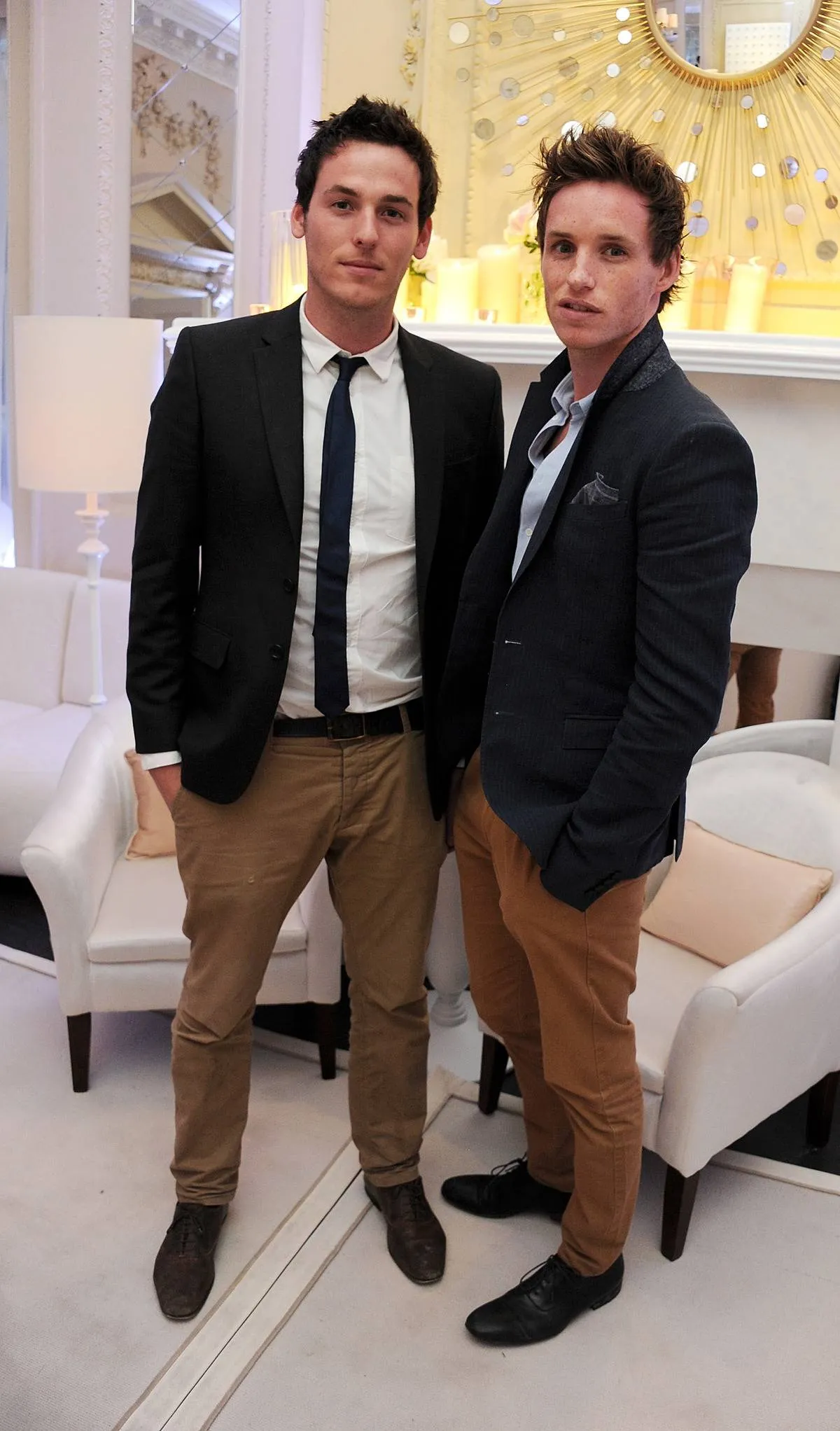 Actor Eddie Redmayne (R) and brother Tom Redmayne attend the private opening of OMEGA House