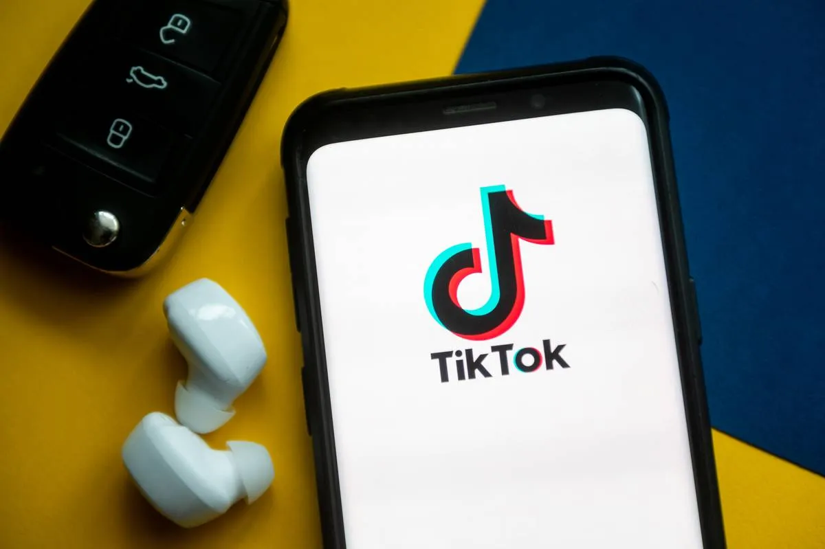 In this photo illustration a TikTok logo seen displayed on a...