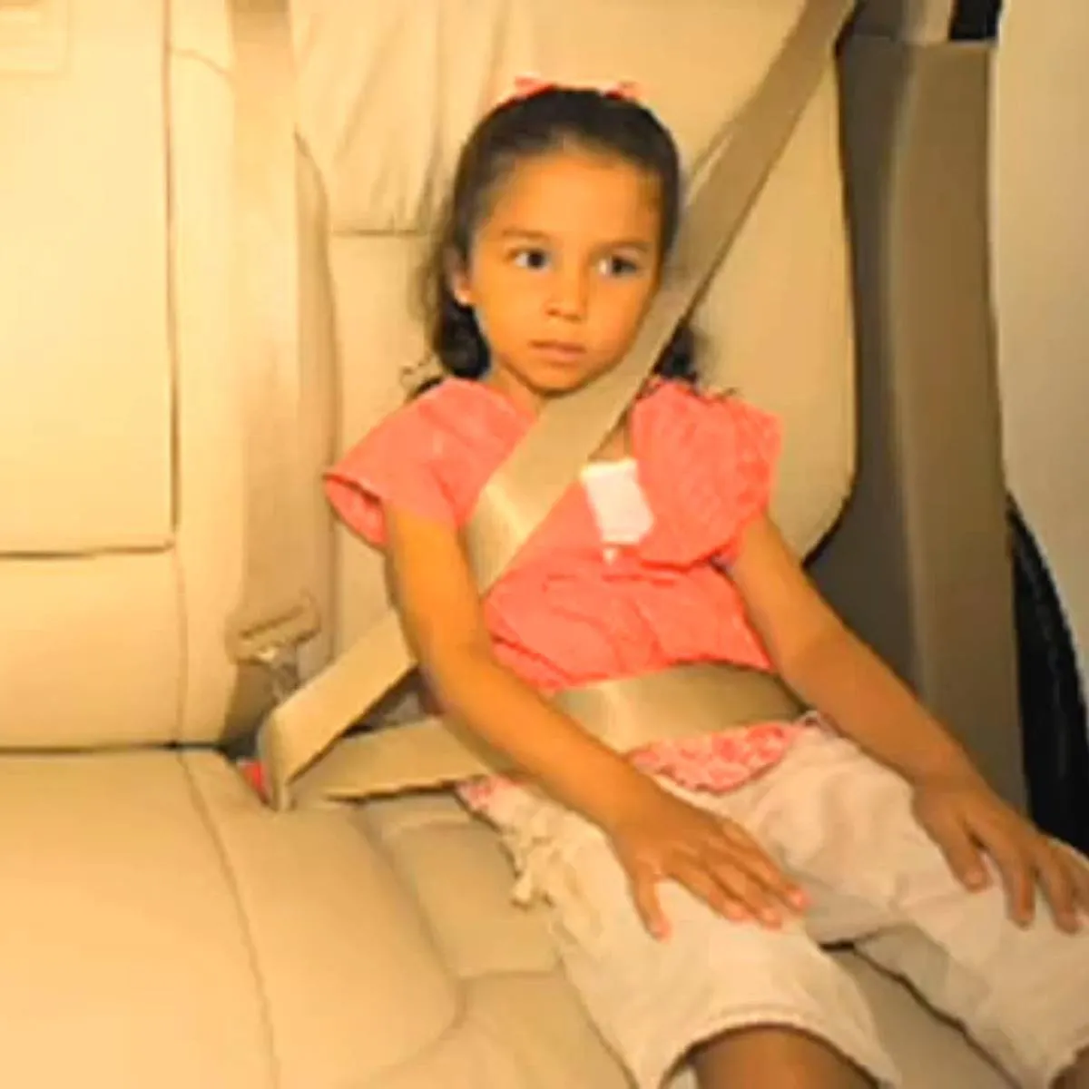girl sitting in car without carseat
