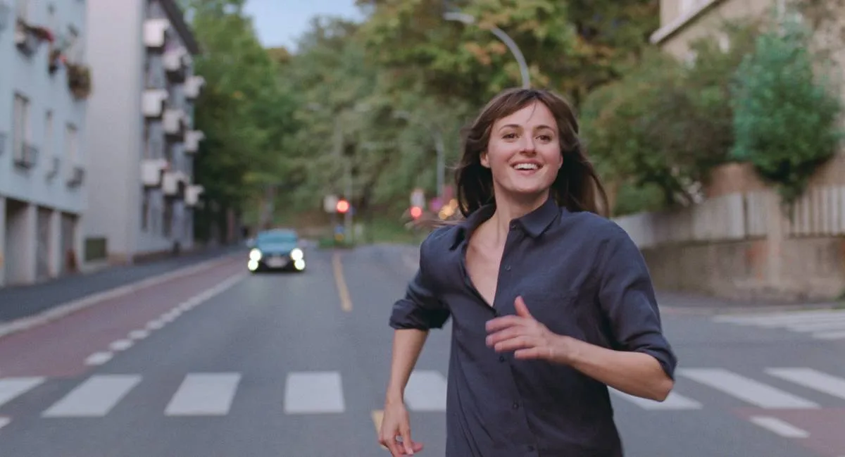 woman running down the street smiling