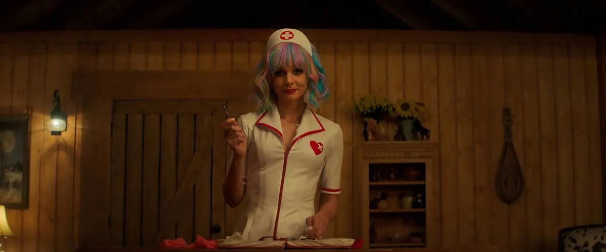 Carey Mulligan standing in nurse costume and multi-colored hair in Promising Young Woman