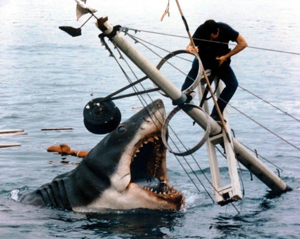 Jaws attacking Roy Scheider as Cheif Martin Brody amid ruins of boat