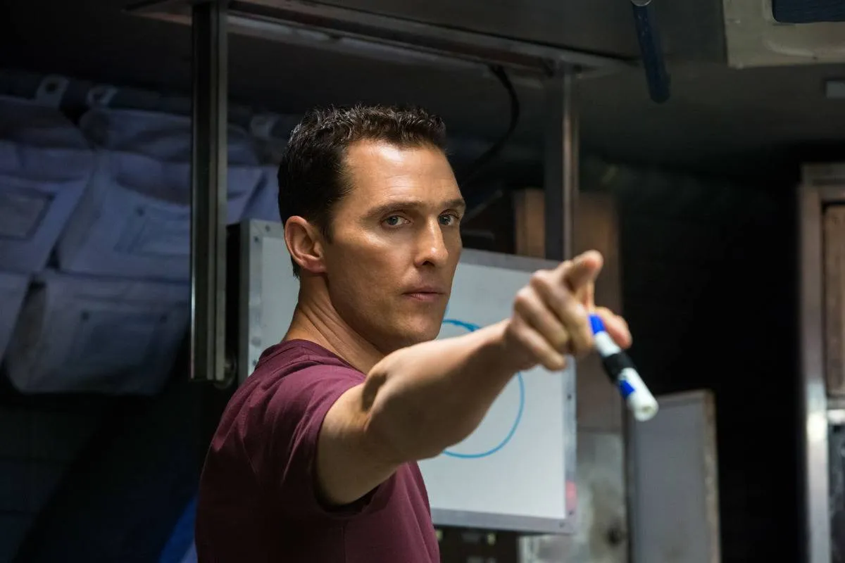 Matthew McConaughey pointing with dry erase marker in his hand in front of drawn circle in Insterstellar