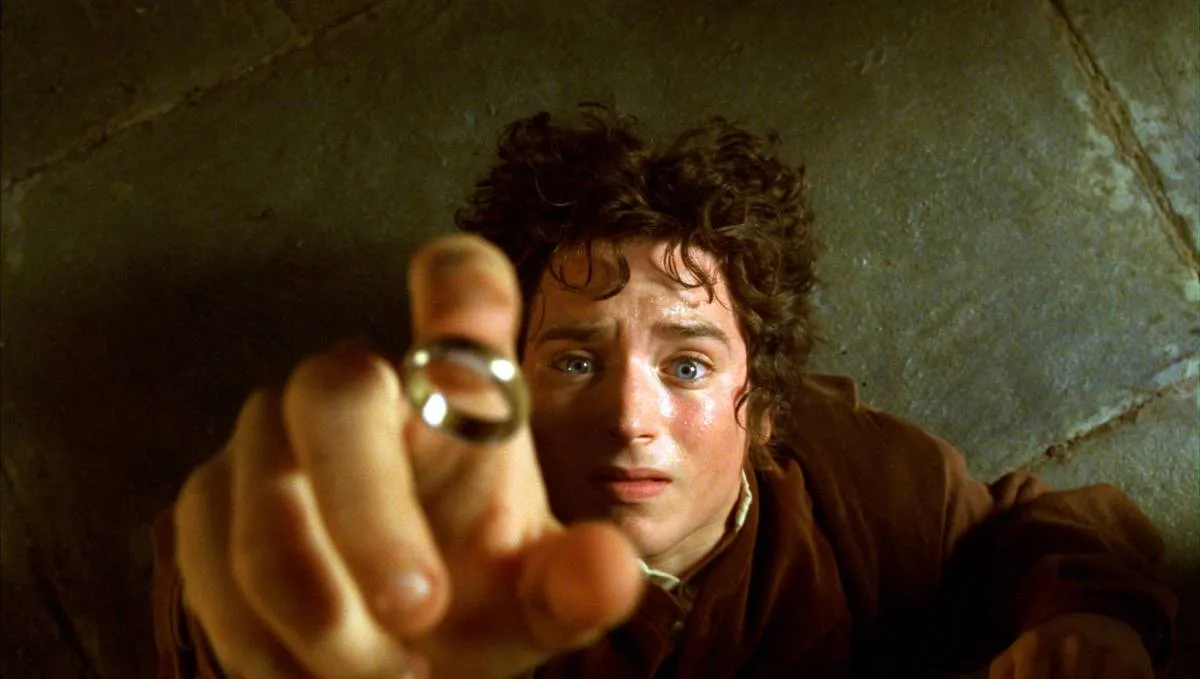 Elijah Wood nervously putting finger in ring as Frodo Baggins in The Lord Of The Rings Fellowship of The Ring