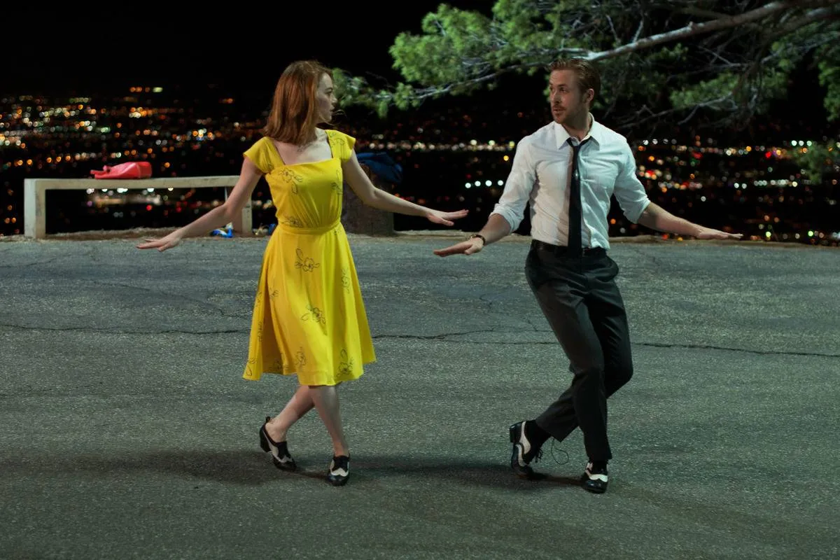 Emma Stone as Mia Dolan dancing with Ryan Gosling as Sebastian Wilder in La La Land