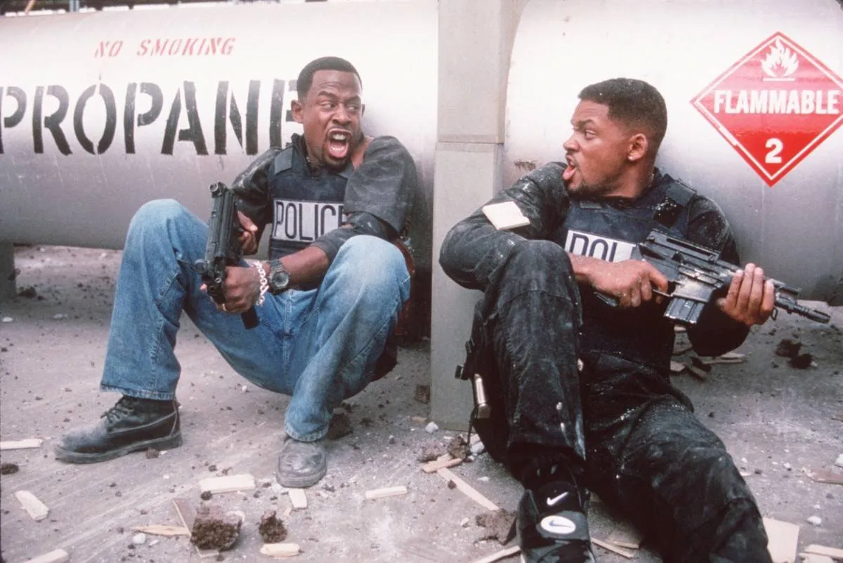 Martin Lawrence and Will Smith crouching near propane tank in Bad Boys