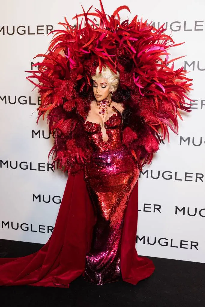 cardi b in a red sequin dress and feather covering