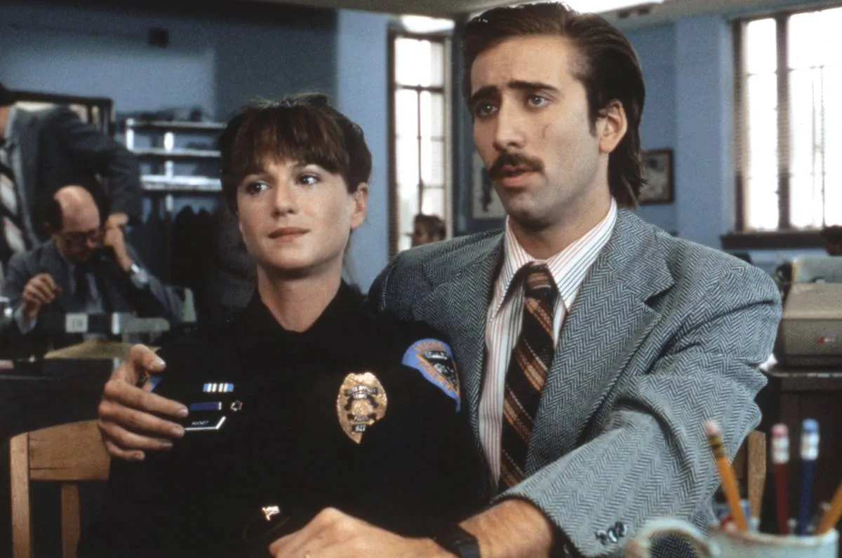a police woman and a man in a suit in raising arizona