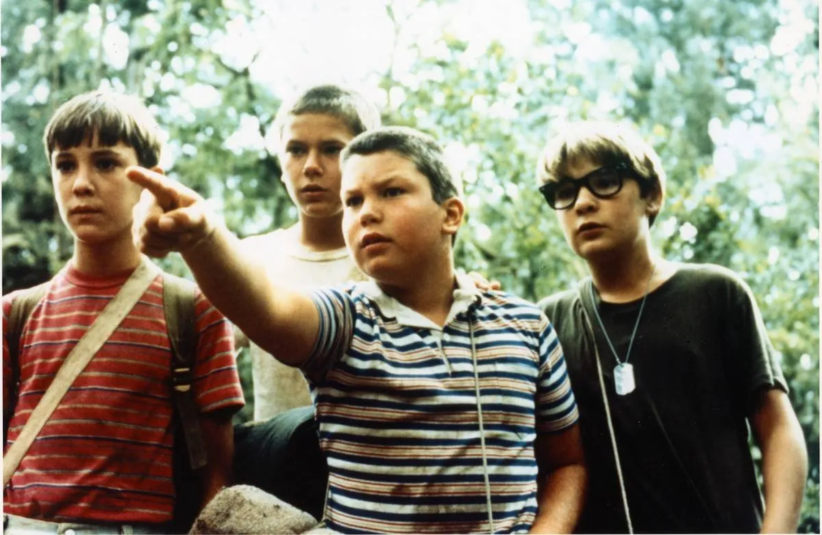 a group of boys in the woods in stand by me