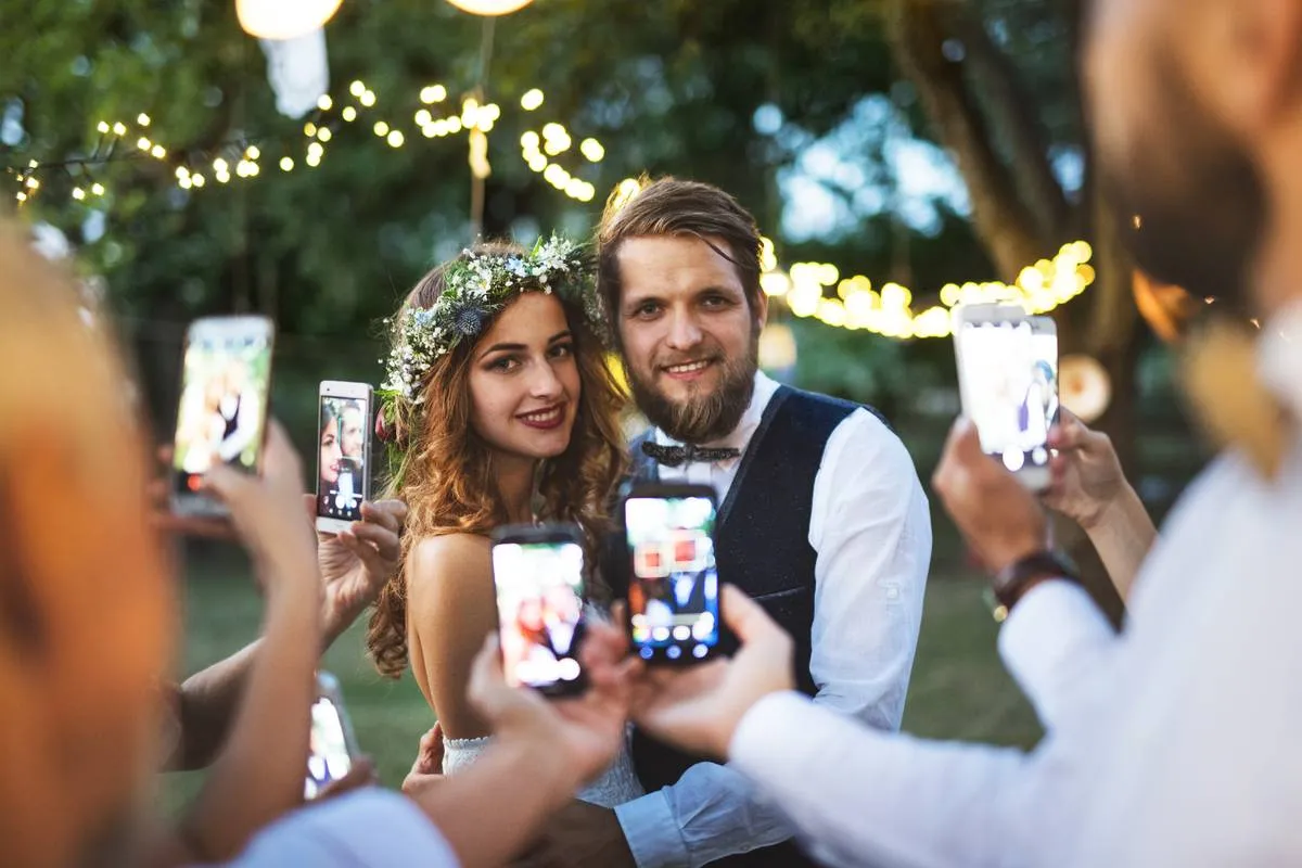 guests-with-smartphones-taking-photo-of-bride-and-2022-02-02-03-47-53-utc