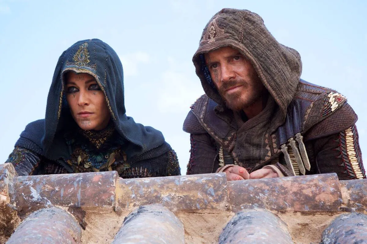 assassin's creed man and woman with robes over a wall